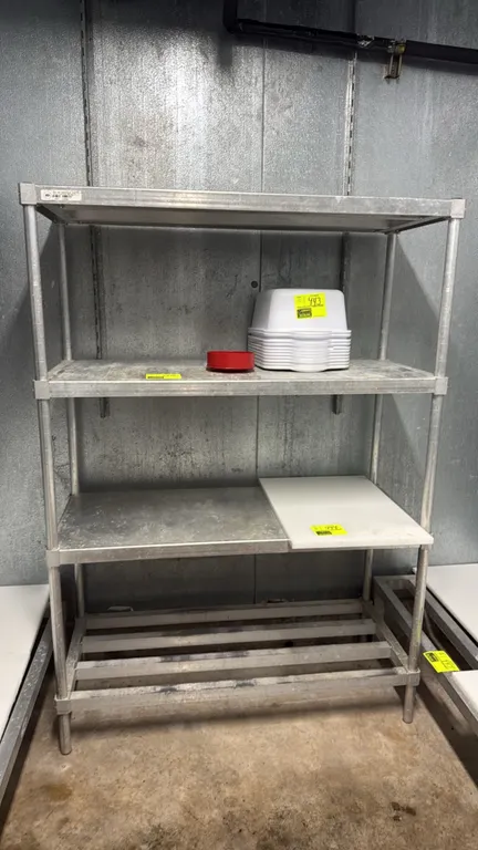 Aluminum 4-tier shelving rack. Features aluminum construction with solid upper shelves and a slatted bottom shelf. Dimensions: 48" x 20" x 68". Conten