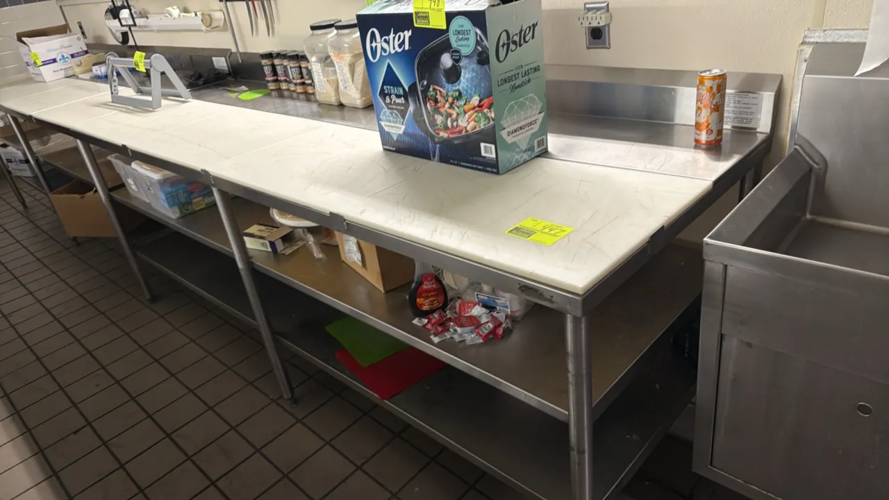 Stainless steel poly top work table. Features backsplash, poly cutting board top sections, and double stainless steel undershelves. 96" x 30". Mounted