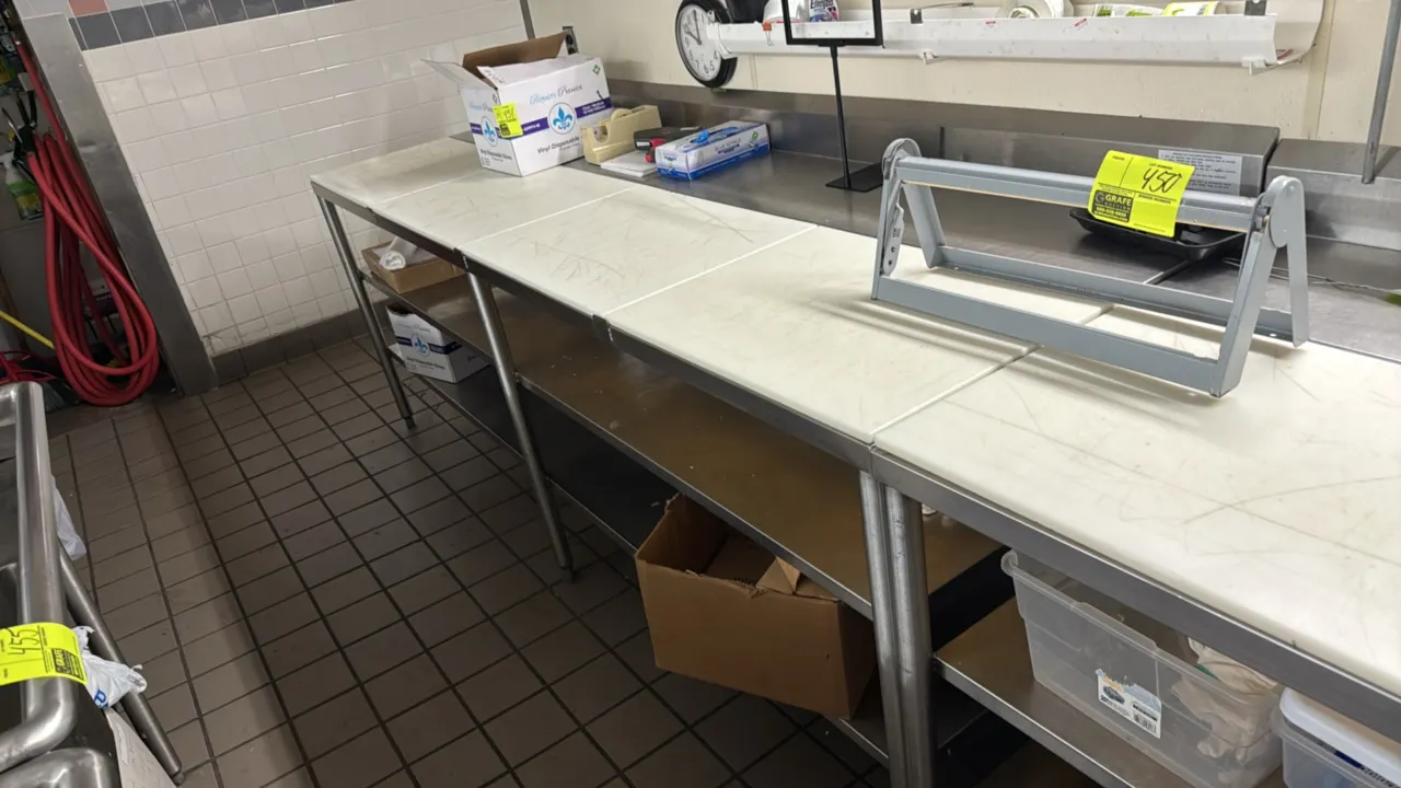 Stainless steel poly top work table. Features removable poly cutting board top sections, rear backsplash, and stainless steel undershelf. 96" x 30". M