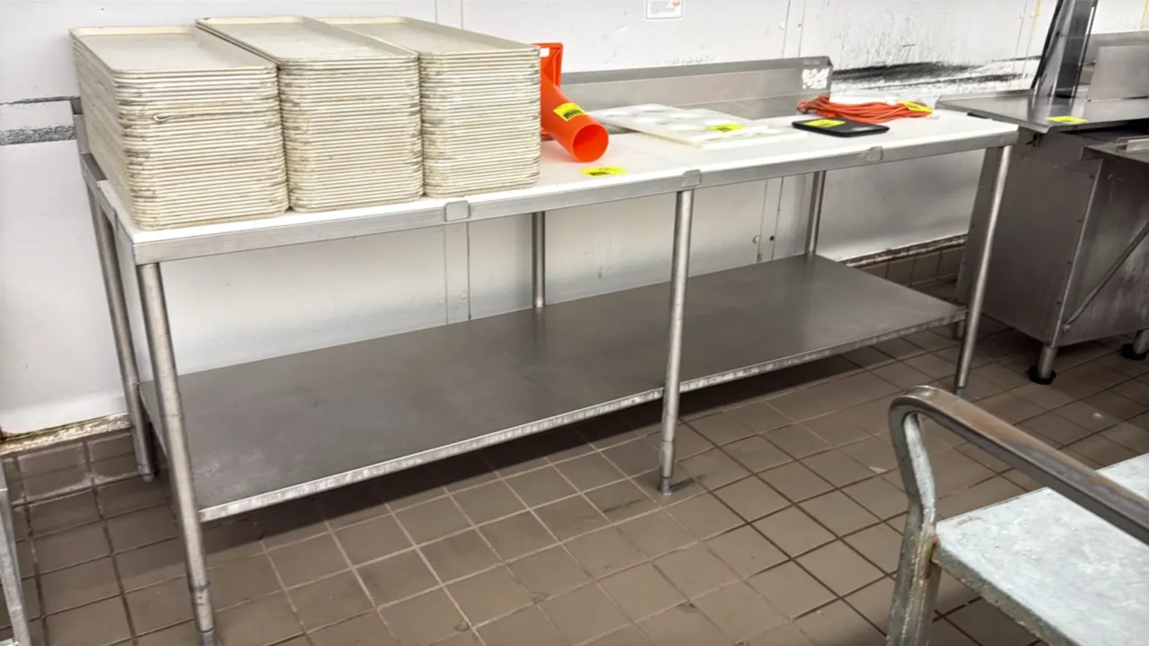 Stainless steel poly top prep table. Features poly cutting board surface, integrated rear backsplash, and full-length stainless steel undershelf. 96"