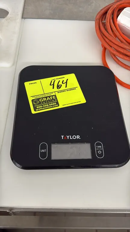 Taylor digital scale. Features 11 lb capacity, digital LCD readout, and touch controls for unit conversion and tare function. Background items not inc