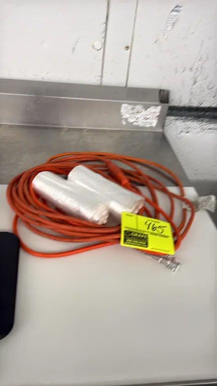 Extension cord and can liners lot. Includes (1) orange flexible extension cord and (2) rolls of clear plastic can liners.