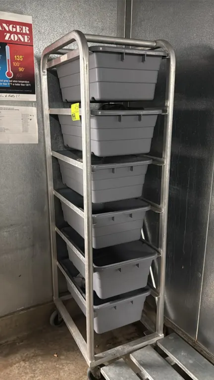 Aluminum meat lug rack. Features 6-tier slide capacity and includes (6) gray poly meat lugs. Mounted on casters.