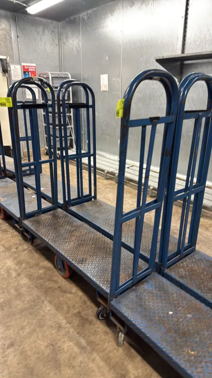 U-boat platform stocking carts. Features blue steel construction with diamond plate deck and tall tubular end handles. 4'L. Mounted on rigid center wh