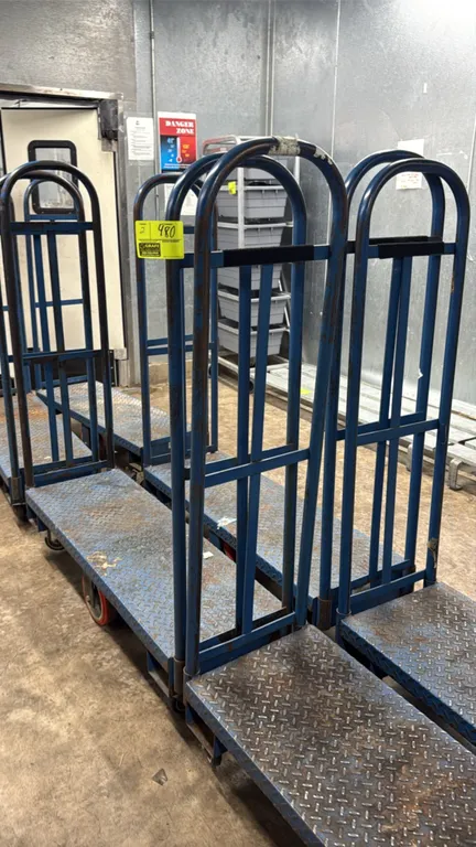 U-boat platform carts. Features blue steel construction, diamond tread deck, and dual tall tubular end handles. 4'L. Mounted on casters.
