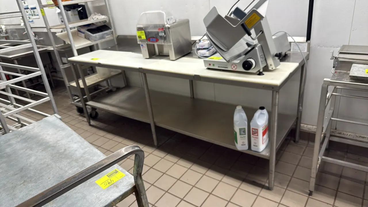 Stainless steel poly top work table. Features removable poly cutting board top surface, rear backsplash, and stainless steel lower undershelf. 96" x 3