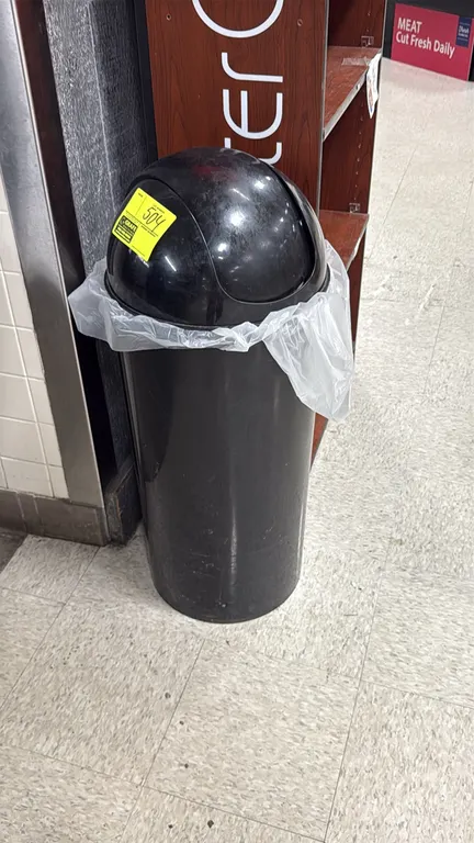 Poly torpedo trash can. Features black plastic construction with a dome swing top.