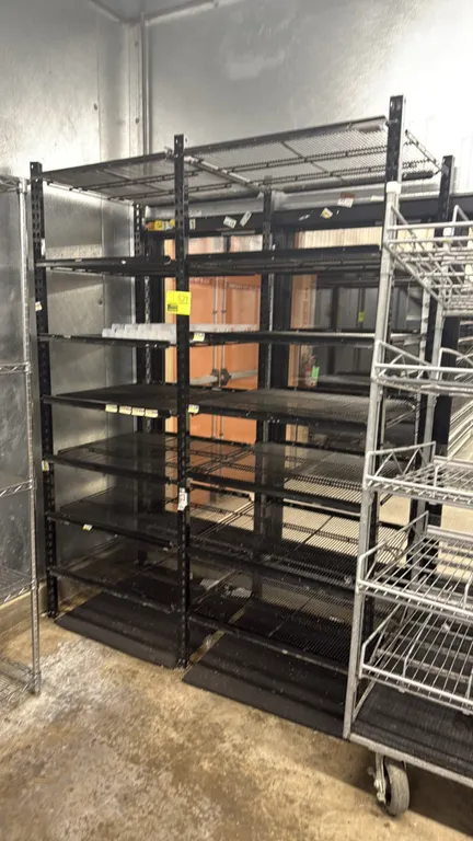 2-section dairy cooler metal display rack. Features black metal construction with multi-tier adjustable wire shelves and price tag channels. Designed