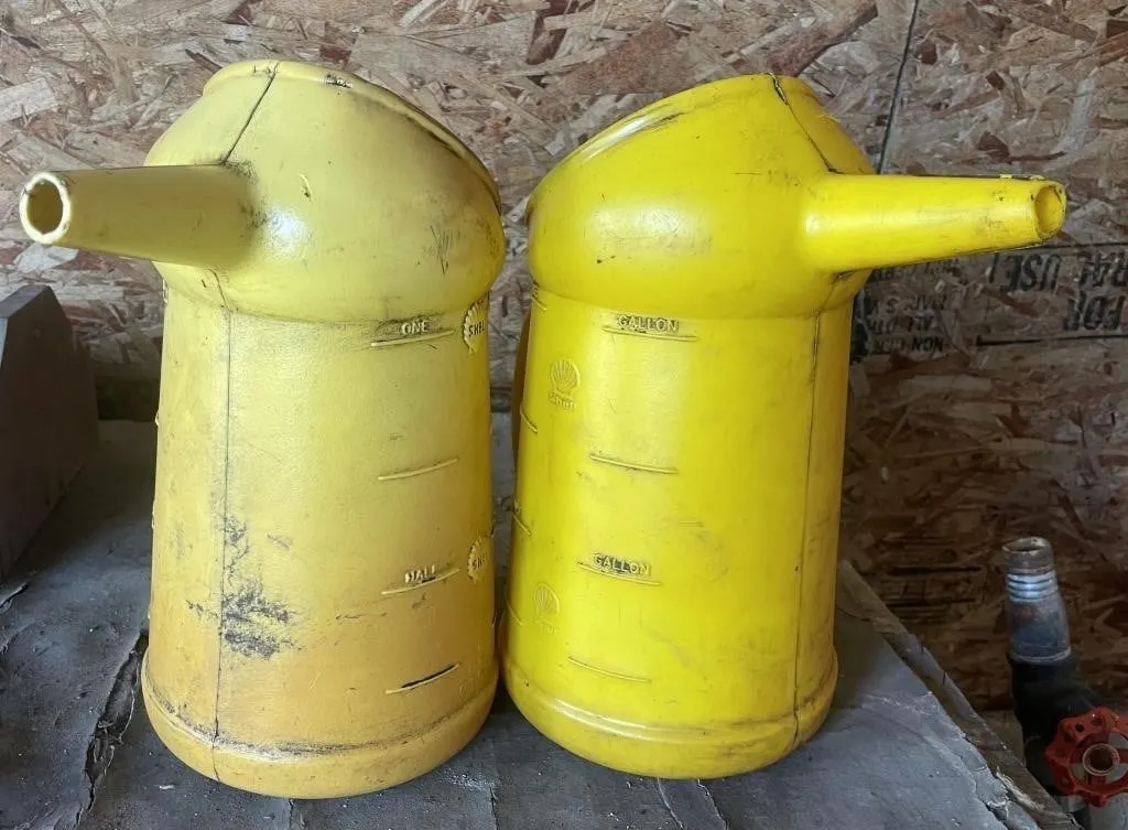 Vintage Shell Oil 1-gallon measuring jugs.