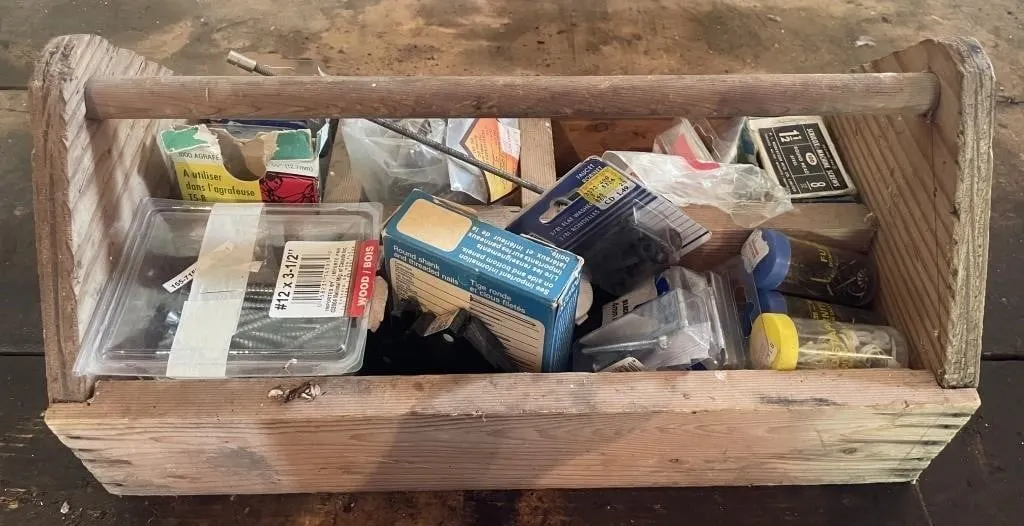 Wooden caddy full of fasteners, furniture tacks,
