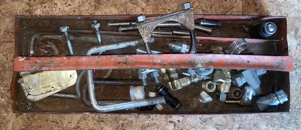 Tray containing U-bolt clamps, brass fittings,
