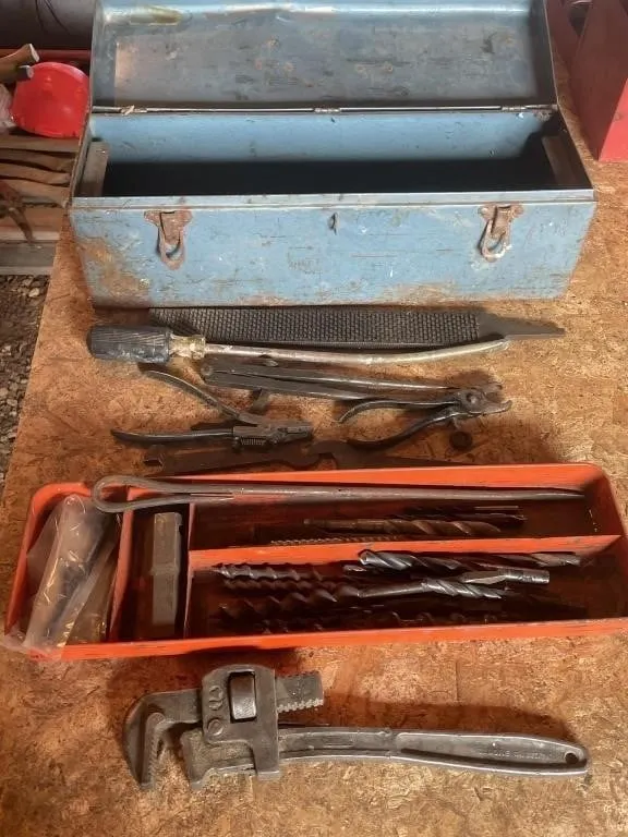 Toolbox with drill bits, pipe wrench, pliers and