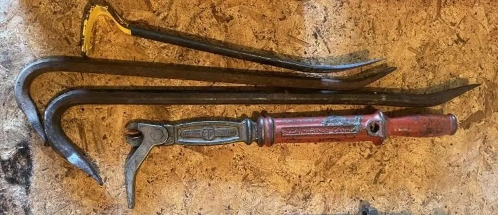 Three pry bars and a vintage nail puller