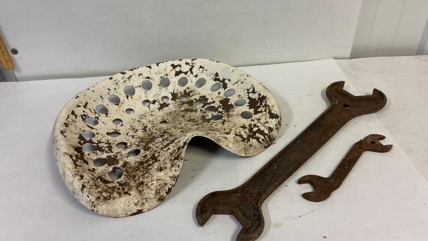 Tin seat and antique wrenches