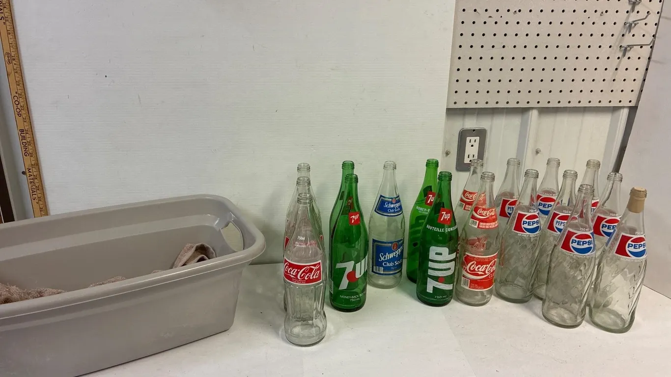 18 glass pop bottles. Assorted