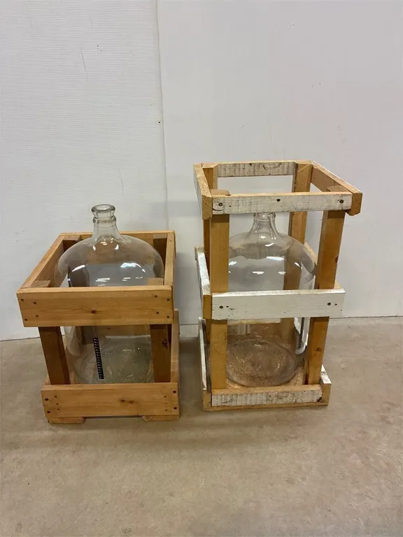 2 glass carboys with crates