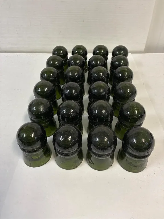 24 light green glass insulators.