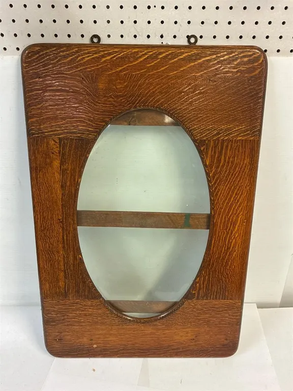 Beveled glass with wood frame. Frame is 19 x 29”