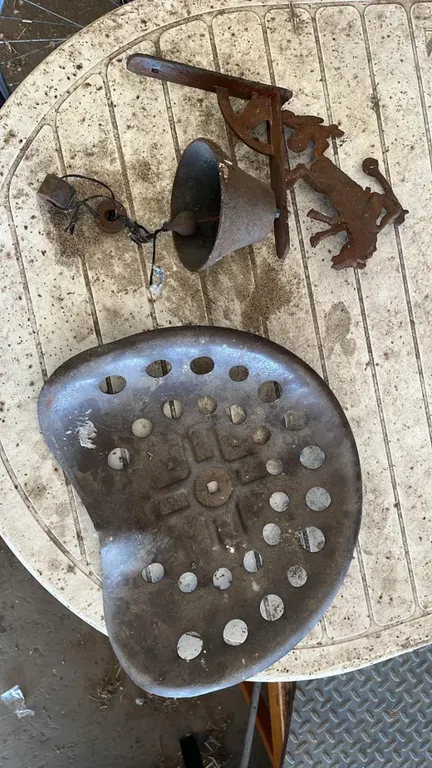 OFFSITE - Bucking Bronco bell and old tractor seat