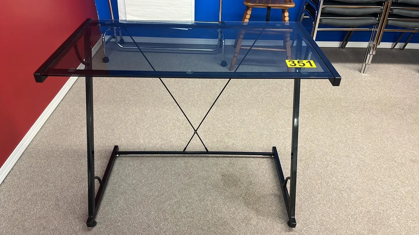 OFFSITE - Glass table on metal stand , 20”x36”x30” tall.