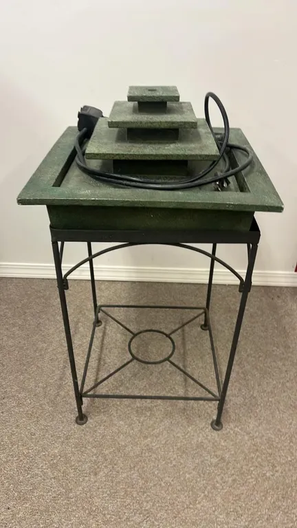 OFFSITE - Fountain with stand and pump, approximately 15”x15”x29” tall.