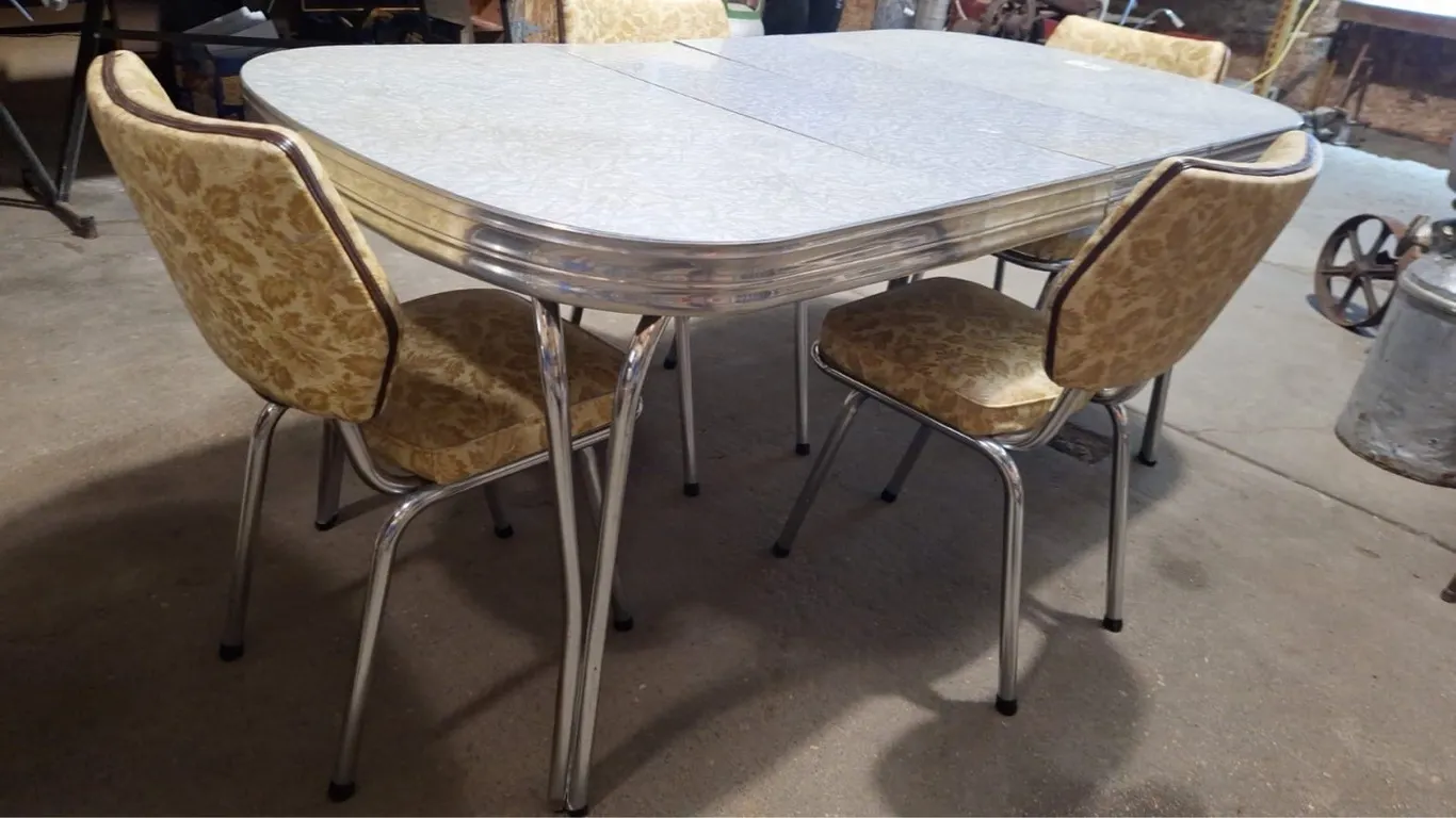 Antique table with 4 chairs. Has 2 leafs. 70" L x 36" W