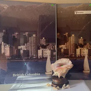 Framed Vancouver and British Columbia Posters with Conch Shell on Wooden Stand