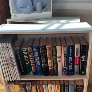 White Two-Shelf Bookcase with Hardcover Books and Stoneware Dinnerware Set