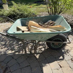 Steel Wheelbarrow With Single Pneumatic Tire And Firewood