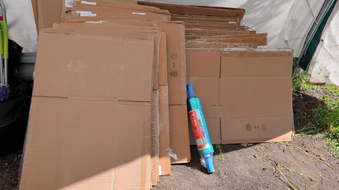 Flattened Cardboard Moving Boxes and Movers Wrap