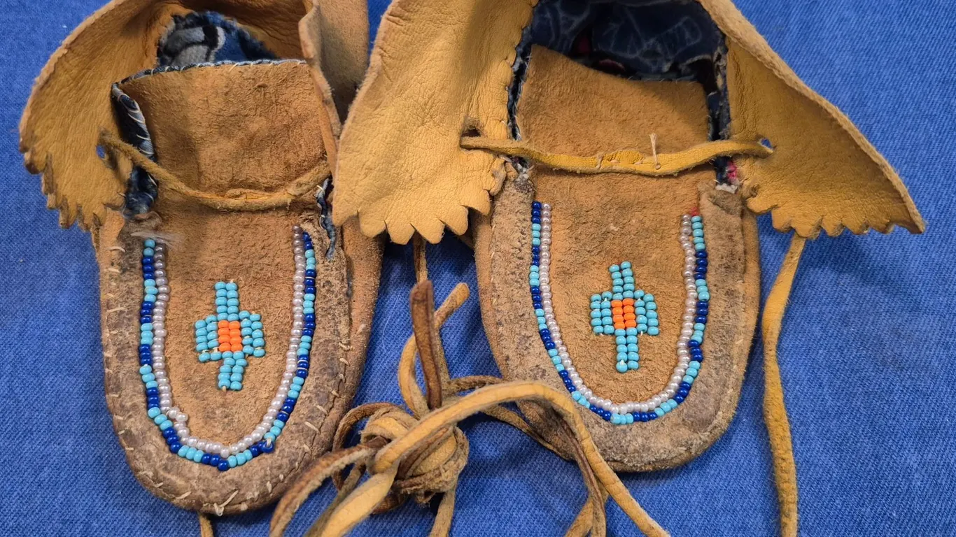 Pair of baby-size hand-stitched moose hide beaded mocassins, good condition