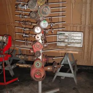 large steel rack with assorted pulleys, bearings, gears, etc.