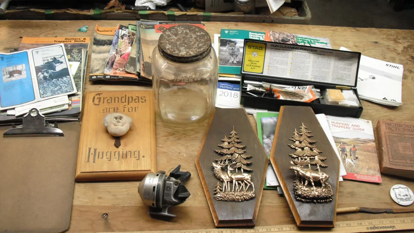 gun cleaning kit, knife, fishing reel, books, etc.
