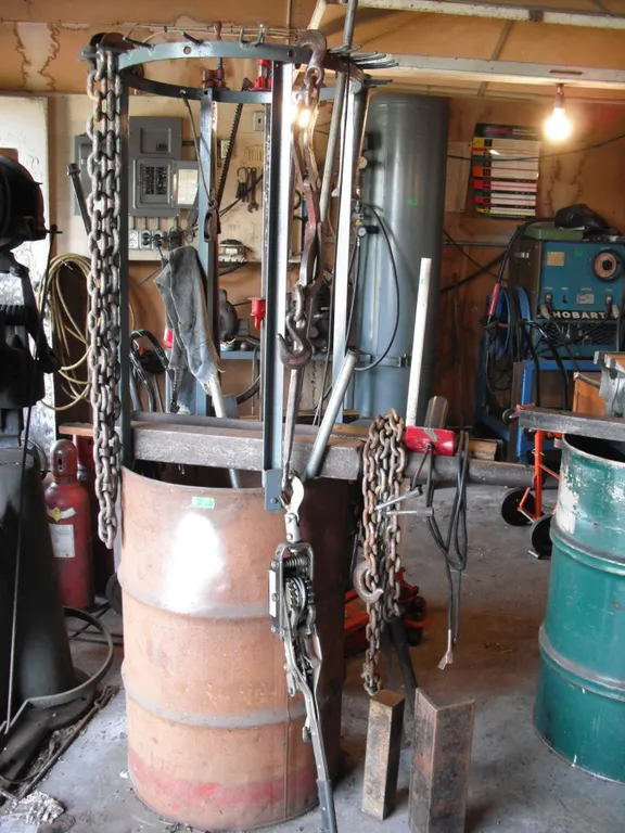barrel made into work rac with cable winch, chains, etc.