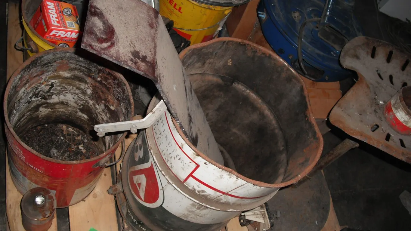 pallet of oil barrels (BA, Shell, Co-op), hub caps, engione parts, etc.