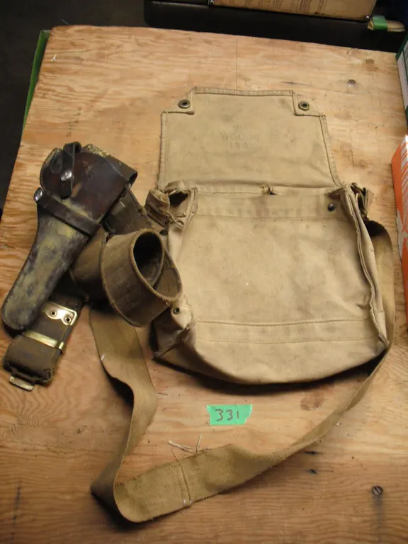 leather gun holster & vintage satchel marked "VII Woods 1941"