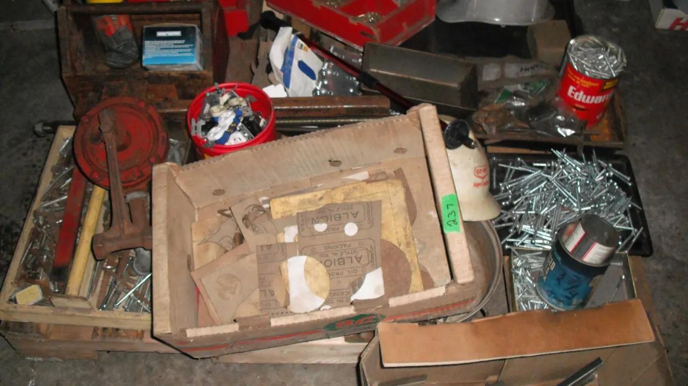 pallet of lag bolts, saw blades, electrical, pump piece, etc.