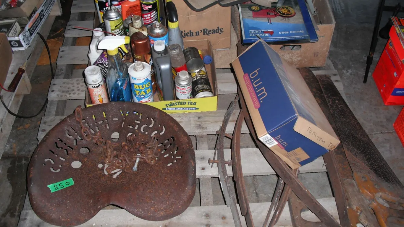 pallet of automotive fluids, carpenters belt, Massey-Harris tractor seat, etc.