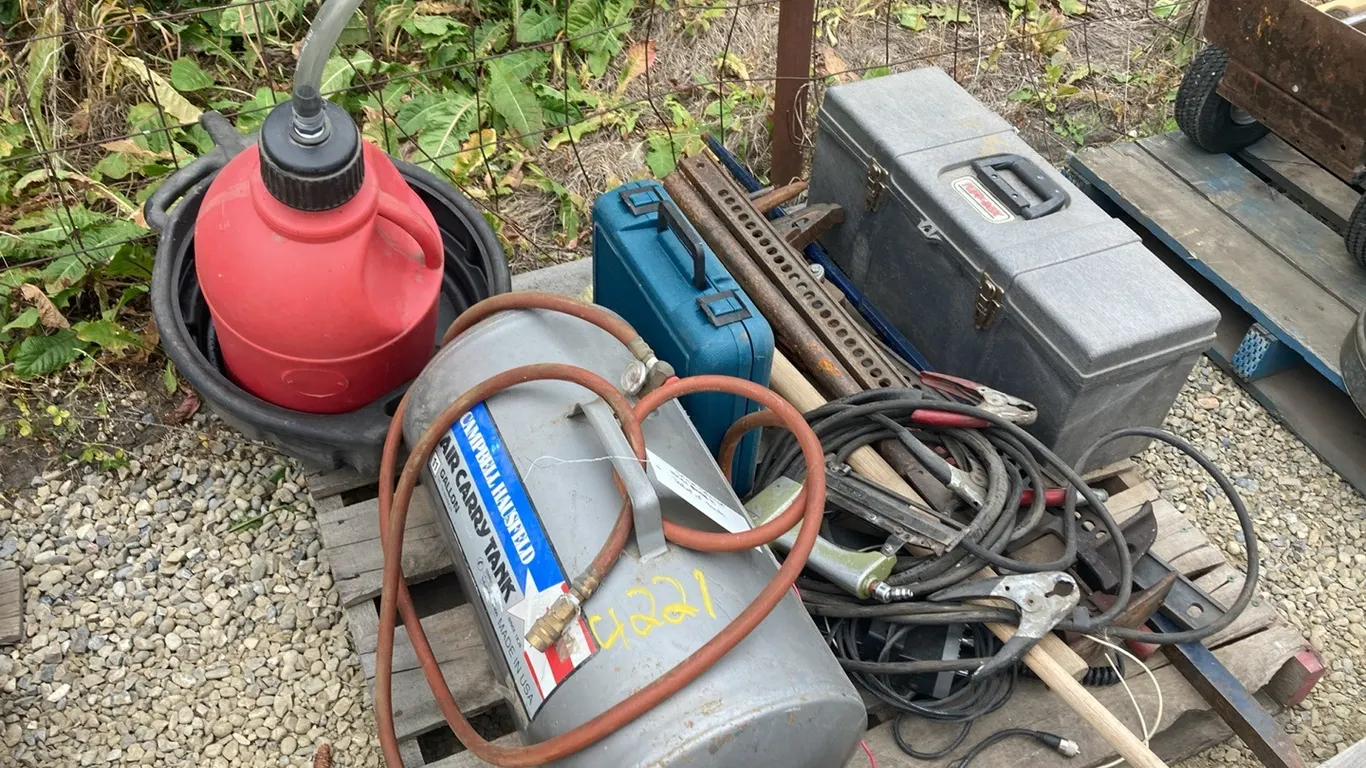 Bosch Jigsaw with Blades, CB Walkie Talkie, Ary Finishing Nailer, Jackal Prybar and Pick, Oil Drain Pan, Gas Can, Booster Cables, Portable Air Tank, S
