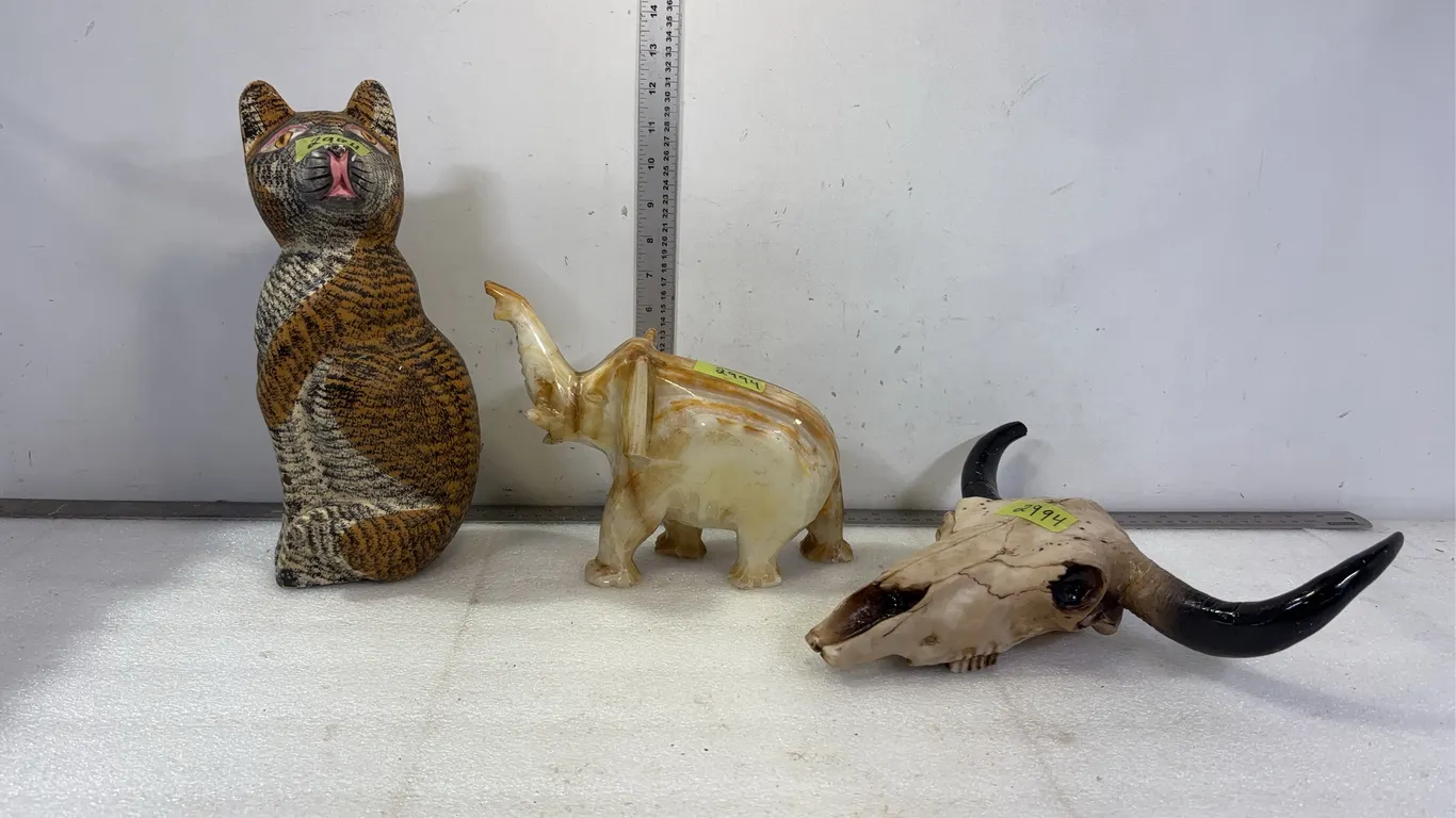 1 - Bull Skull Mini Replica, Approx 9"x11", 1 - Stone Elephant statue, Approx 10"x9", 1- Wooden cat statue, Approx 13" tall, *Unre