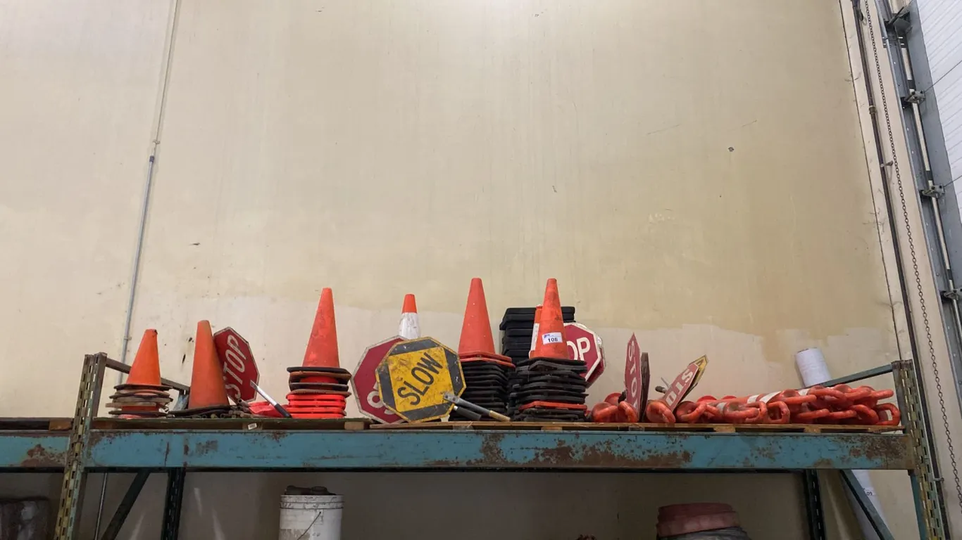 SHELF OF ASSORTED TRAFFIC CONTROL ITEMS- DELINEATORS, TRAFFIC CONES & HAND SIGNS