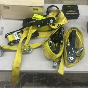 Ratchet tie-down straps. Features yellow webbing, ratcheting tensioners with molded grip handles, and metal double J-hooks.