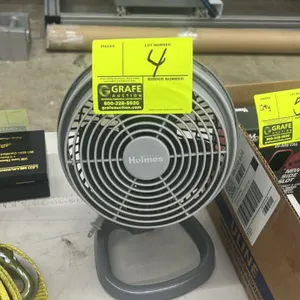 Holmes desktop fan. Features gray molded plastic construction, adjustable tilt head, and integrated tabletop base.