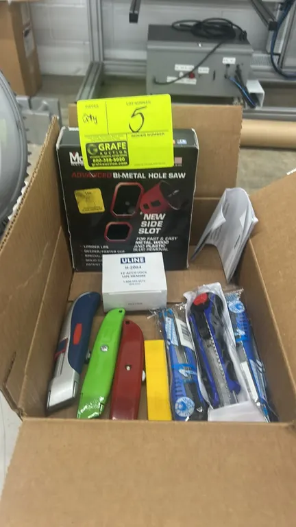 Hand tool lot. Includes assorted box cutters and utility knives, Uline H-2064 12' Accu-Lock tape measure, and a Morse Advanced bi-metal hole saw.
