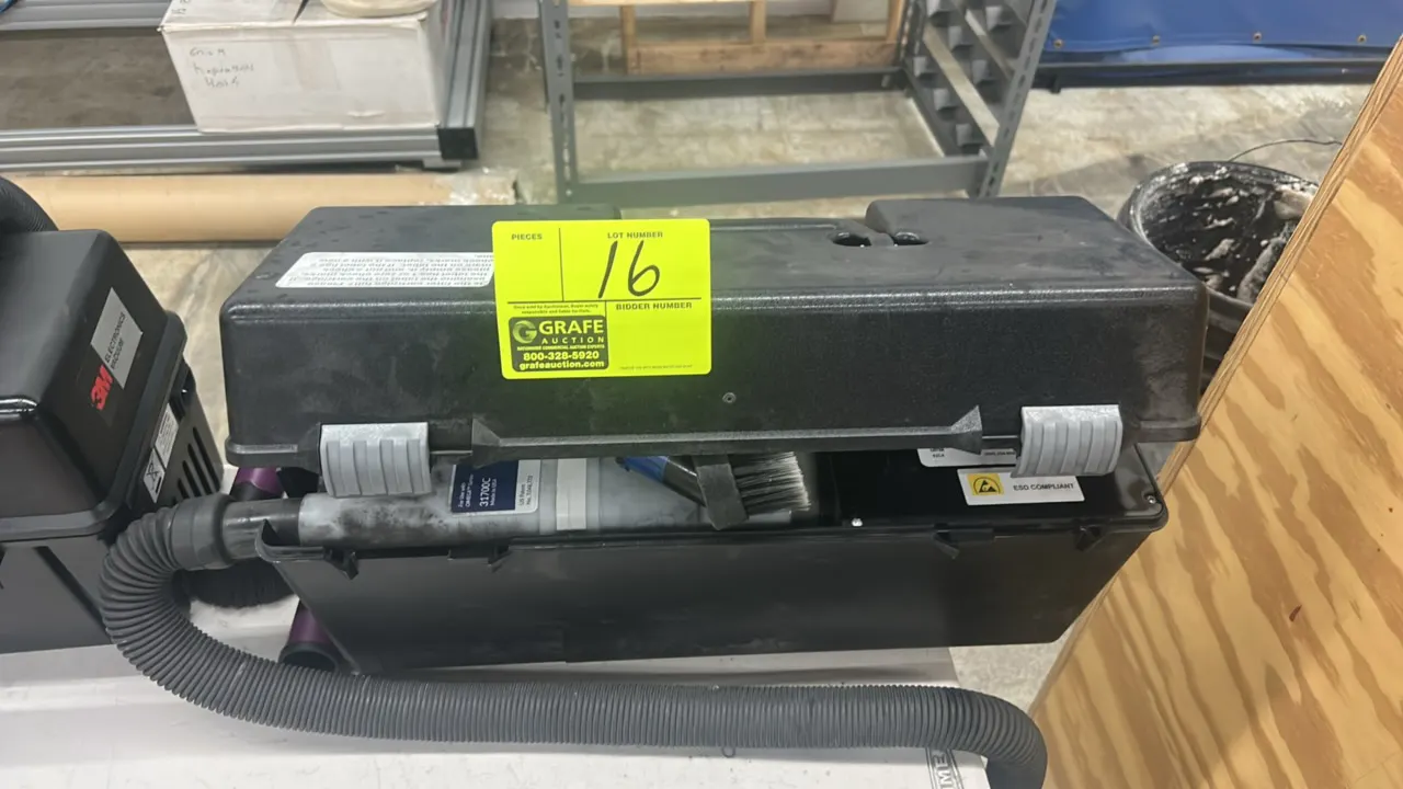 SCS electronic service vacuum. Features ESD-compliant portable case design with carry handle, flexible hose, brush attachment, and filter cartridge.
