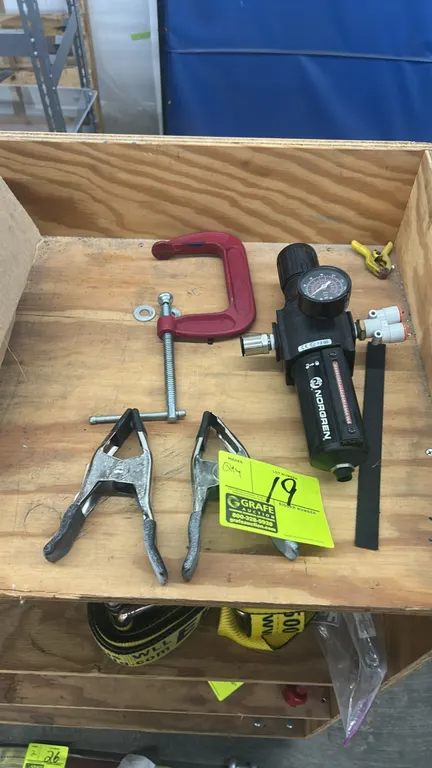 Assorted shop tools and pneumatic components. Includes (1) 4" C-clamp, (2) metal spring clamps with coated grips, and (1) Norgren Excelon pneumatic fi