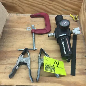 Assorted shop tools and pneumatic components. Includes (1) 4" C-clamp, (2) metal spring clamps with coated grips, and (1) Norgren Excelon pneumatic fi