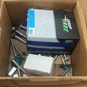 Assorted hardware and fasteners. Includes lag bolts, screws, washers, brackets, metal strapping seals, Grip Fast fasteners, and remaining boxed conten