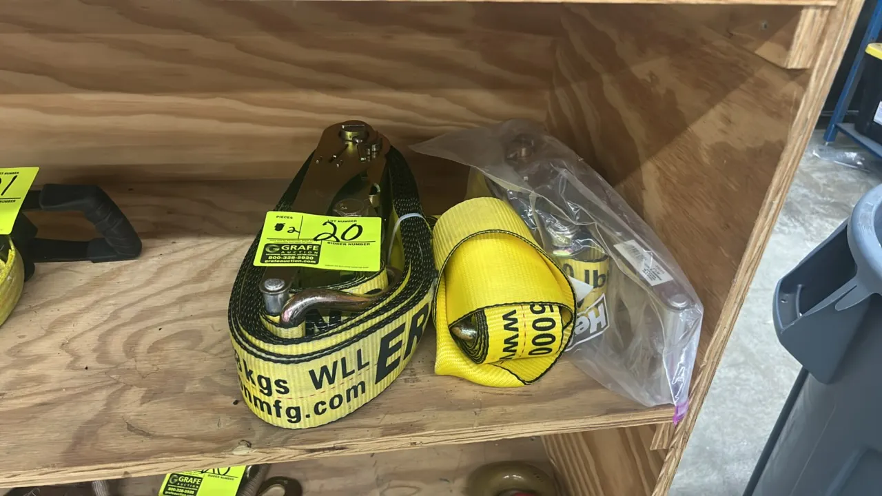 Erickson ratchet tie-down straps. Features yellow webbing, steel ratchet mechanisms, and metal hooks. Rated for 5,000 lbs (2,268 kg) capacity.