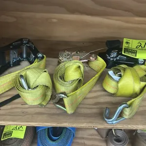 Assorted ratchet tie-down straps. Features yellow webbing, heavy-duty mechanical ratchets with grip handles, and metal wire J-hooks.